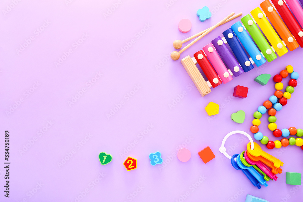 Colorful kids toys on purple background. Top view Colorful kids toys on purple background. Top view