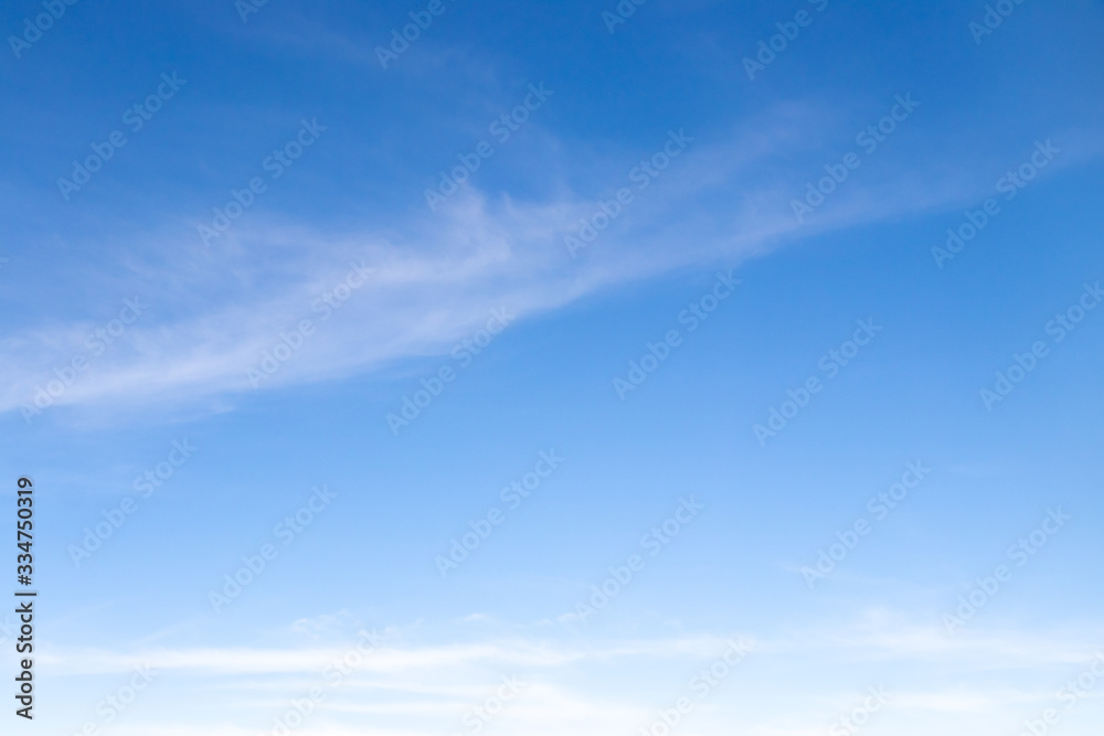 Clear blue sky with white cloud background