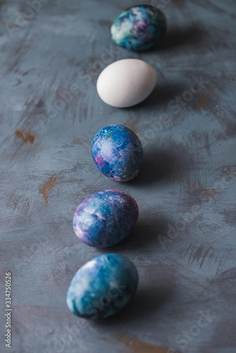  Easter holiday. Easter colorful eggs on a blue surface.
