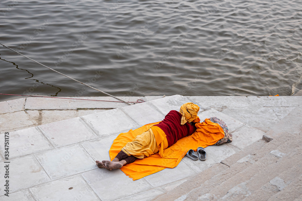 Holy Saddhu Indian Man meditating near the holy Ganges river Holy Saddhu Indian Man meditating near the holy Ganges river