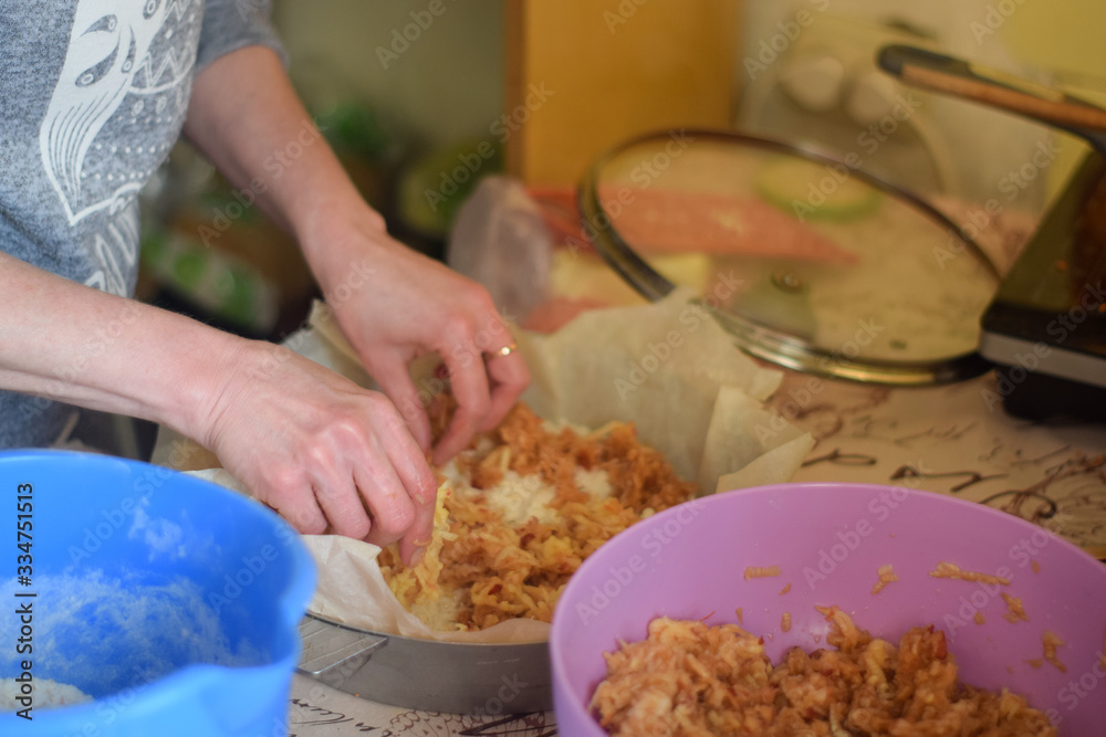 Woman cooks apple pie in the kitchen close up