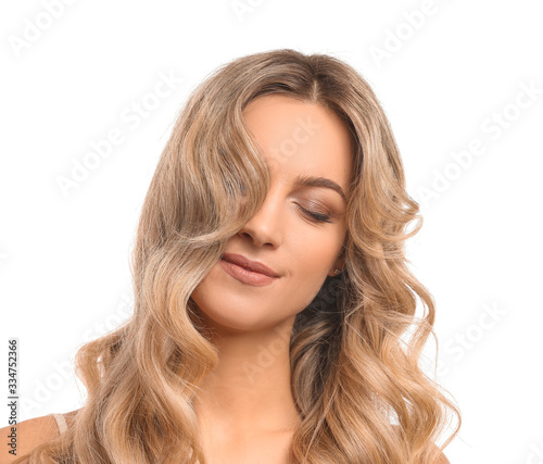 Beautiful young woman with curly hair on white background
