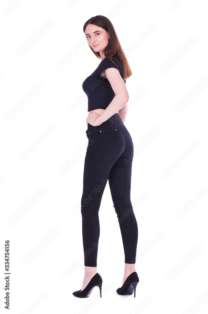 Back view portrait young beautiful brunette woman in black jeans Back view portrait young beautiful brunette woman in black jeans