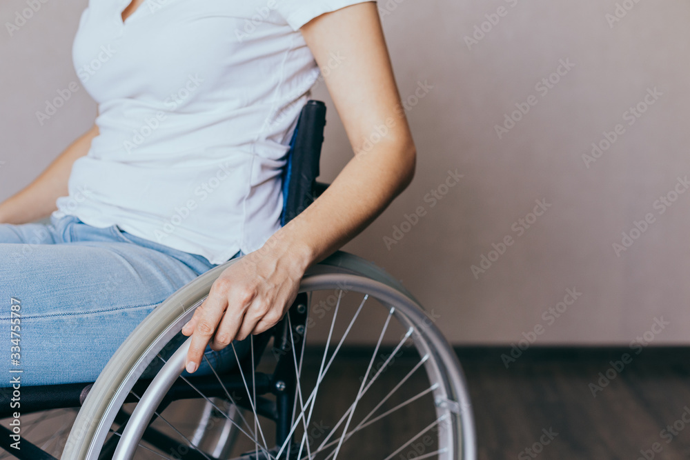 Obraz premium Unrecognizable disabled woman in wheelchair at home. Recovery and healthcare concepts.