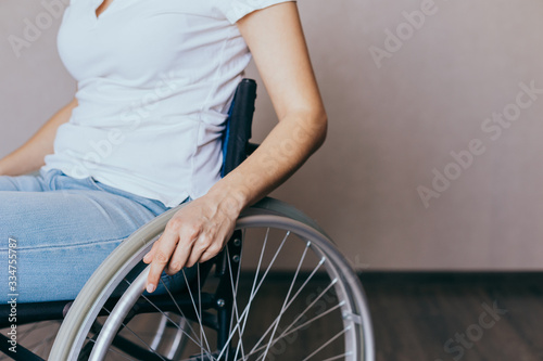 Unrecognizable disabled woman in wheelchair at home. Recovery and healthcare concepts. © Nana_studio