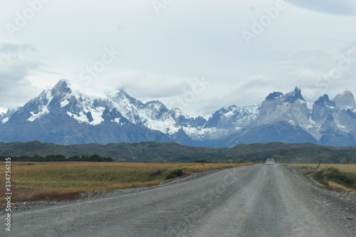 Street to Torres del Paine National Park in Chile, Patagonia with snow covered mountains in background