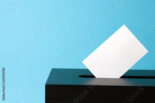 ballot box with voting paper in hole