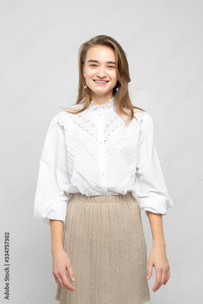 Beautiful young woman portrait. Studio shot, isolated on gray background Beautiful young woman portrait. Studio shot, isolated on gray background