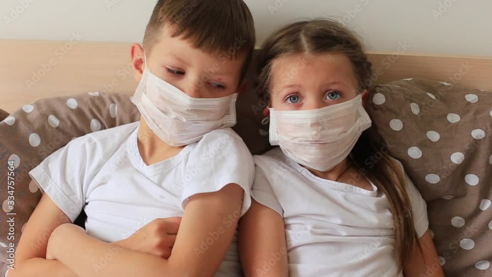 Children in a respiratory mask sits in quarantine at home Children in a respiratory mask sits in quarantine at home