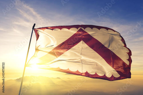 Foto Kortrijk of West Flanders of Belgium flag waving on the top sunrise mist fog