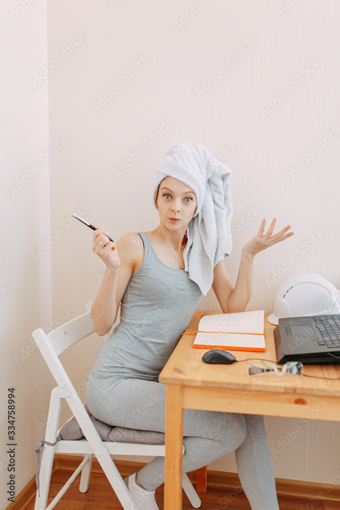 Home office in quarantine, self isolation, stay home, working from home while quarantine, woman with towel on head works at home Home office in quarantine, self isolation, stay home, working from home while quarantine, woman with towel on head works at home