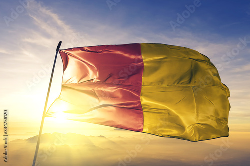 Liege of Liege of Belgium flag waving on the top sunrise mist fog © Oleksii