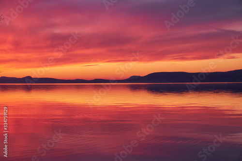 landscape colorful sunset reflecting water and hills at lake Balaton, Hungary