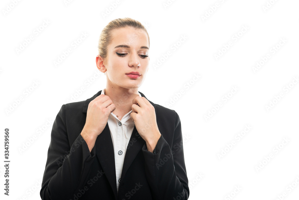 Portrait of beautiful young female assistant manager arranging shirt