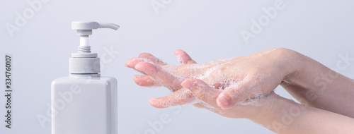Hand washing. Asian young woman using soap to wash hands, concept of hygiene to stop spreading coronavirus isolated on gray white background, close up.