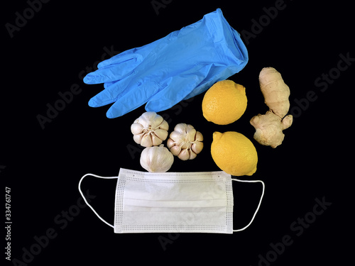 Garlic, ginger, apple and citrus fruits on a black background. Natural vitamins on the table, oranges, grapefruit and mandorin. Concept: Prevention of Viral Infections and Corovirus photo