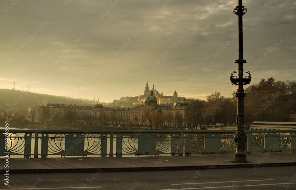 Obraz premium Panoramic view of Prague from a bridge with an asphalted street and a sidewalk with a lamppost (Prague, Czech Republic, Europe)