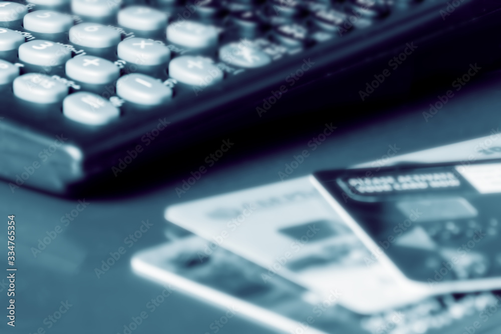 Bank credit cards and calculator, close up. Soft focus. Bank credit cards and calculator, close up. Soft focus.