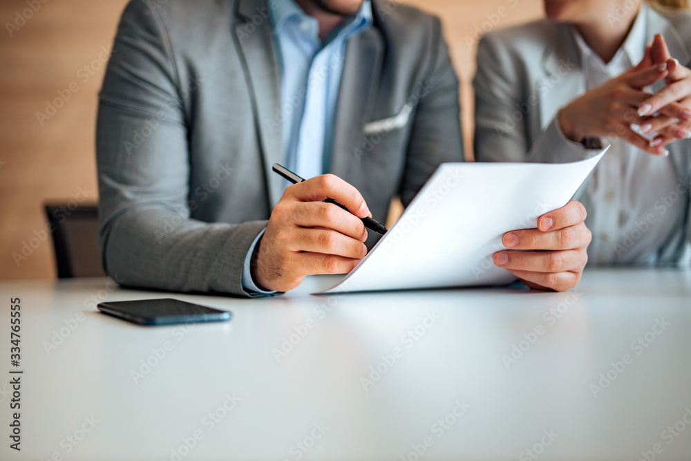 Close-up image of a man signing a document, copy space. Close-up image of a man signing a document, copy space.