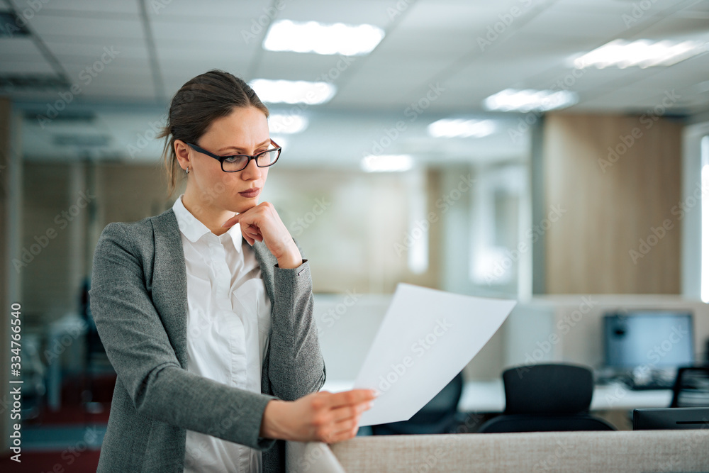 Concentrated manager at work, reading document, portrait. Concentrated manager at work, reading document, portrait.