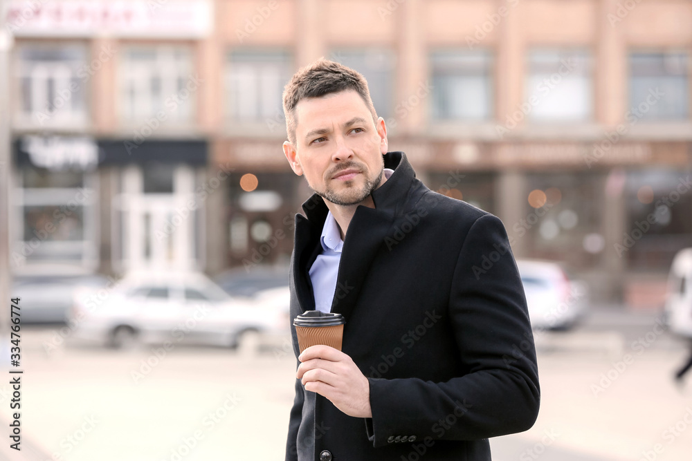 Handsome man with cup of coffee outdoors Handsome man with cup of coffee outdoors