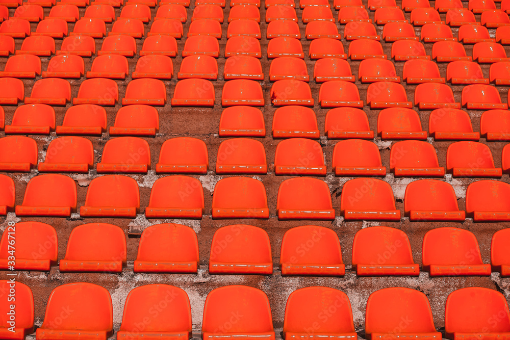 Naklejka premium a bunch of orange bleachers without a single seat.