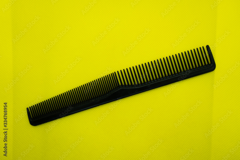 Black comb isolated on color background Black comb isolated on color background