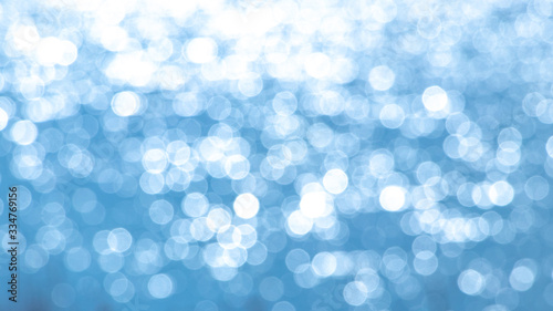 Abstract light blue background with white bokeh_