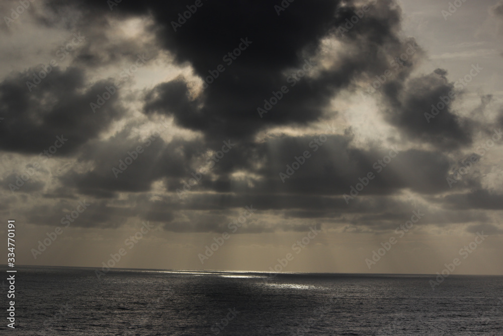 god rays rainy season ocean dark clouds