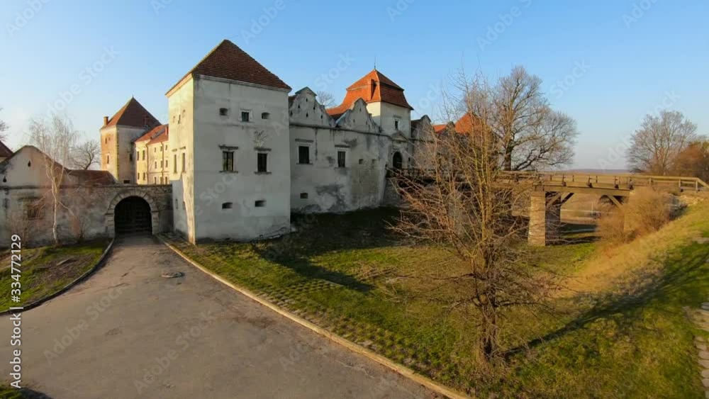 Aerial view of Svirzh castle near Lviv, Ukraine. Lake and surrounding landscape at sunset. Shooting with FPV drone Aerial view of Svirzh castle near Lviv, Ukraine. Lake and surrounding landscape at sunset. Shooting with FPV drone