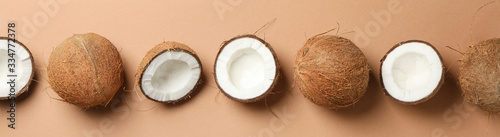Fotografia Flat lay with coconut on brown background, space for text
