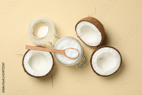 Coconut and cosmetic on beige background. Tropical fruit