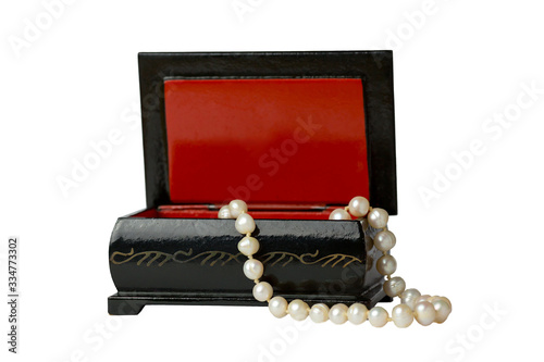  A pearl necklace lies in a casket