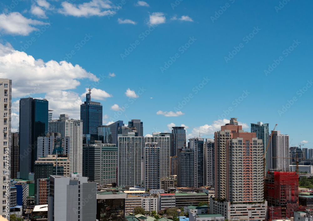 Fototapeta premium Metro Manila city of Philippines with skyscrapers and buildings during clear bright day