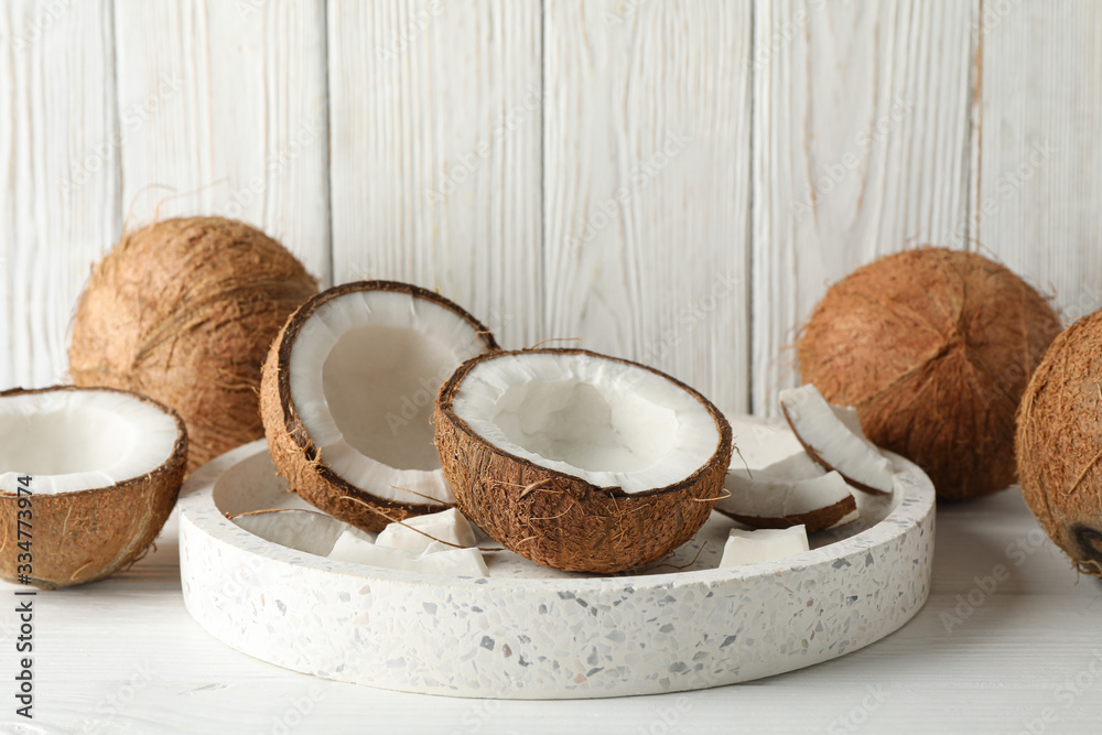 Tray with coconut on wooden background. Tropical fruit