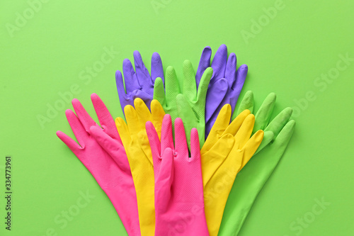 Set of rubber gloves on color background