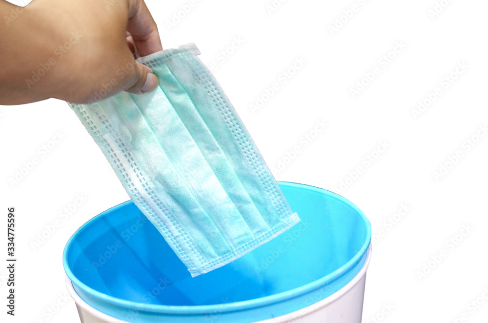 Throw surgical mask in the trash. surgical mask for protection pm 2.5 and corona virus(COVIT-19).air face mask.Hygienic mask on white background with clipping path. Throw surgical mask in the trash. surgical mask for protection pm 2.5 and corona virus(COVIT-19).air face mask.Hygienic mask on white background with clipping path.