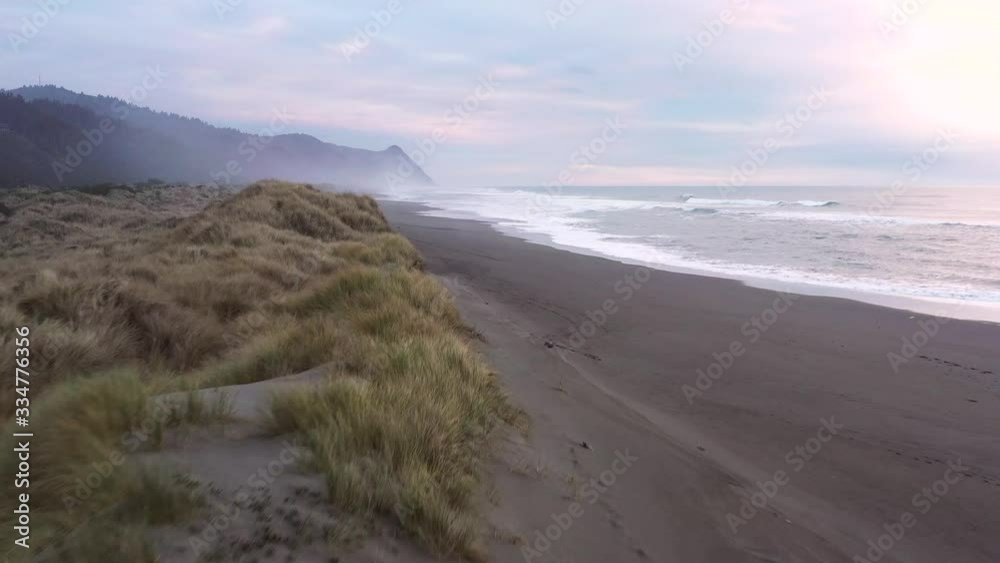 View of Cape Sebastian at sunset from Gold Beach with a bit of color in the clouds and typical coastal fog View of Cape Sebastian at sunset from Gold Beach with a bit of color in the clouds and typical coastal fog