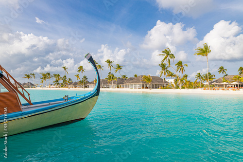 Fototapeta Naklejka Na Ścianę i Meble -  Exotic Maldives beach landscape. Maldives traditional boat Dhoni and perfect blue sea with lagoon. Luxury tropical paradise concept. Amazing landscape
