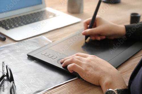 Young female designer worki...