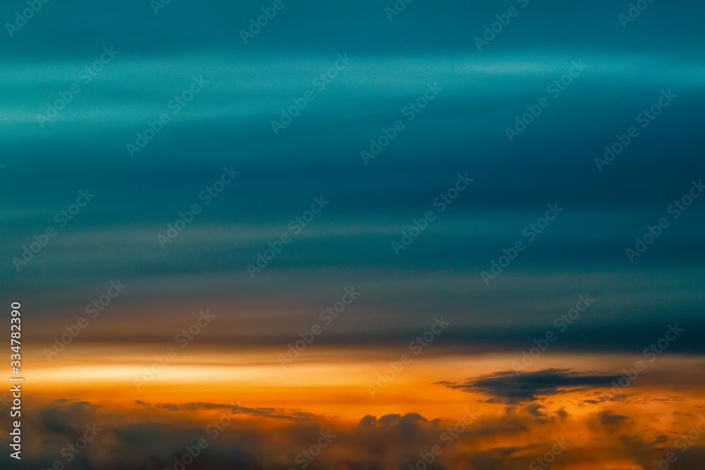 Obraz premium The sky at sunset. Cumulus clouds lit by the rays of the setting sun.