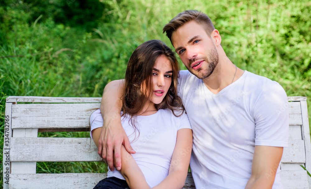 Naklejka premium Boyfriend girlfriend in love. Family weekend. Romantic date in park. Trust and intimacy. Youth hang out. Love and romance concept. Lovers cuddling. Couple in love sit on bench. Summer vacation