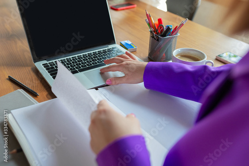 Young caucasian business-woman working in office, looks stylish. Paperwork, analyzing, looking for desicion. Concept of finance, business, girl power, inclusion, diversity, feminism. close up photo