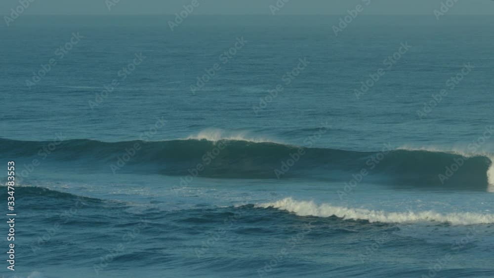 Slow motion wave breaking in blue ocean Slow motion wave breaking in blue ocean