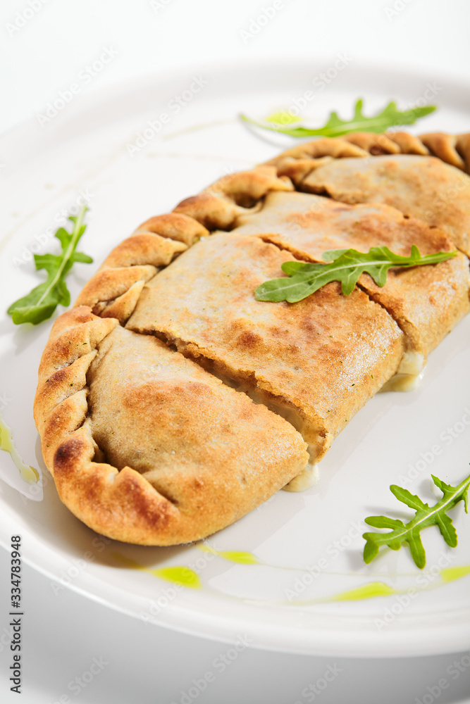 Calzone pizza with Parma ham, tomatoes and mozzarella Calzone pizza with Parma ham, tomatoes and mozzarella