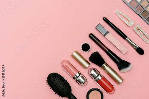 Fototapeta Naklejka Na Ścianę i Meble -  makeup kit, makeup brushes, tulip flower on a pink background