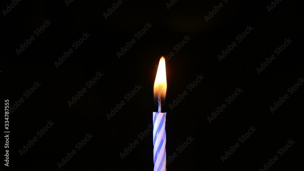 blue birthday candles light on isolated black blue birthday candles light on isolated black