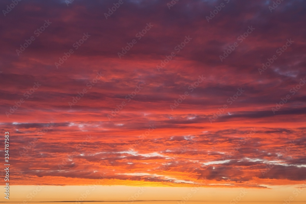 Epic Dramatic bright sunrise, sunset orange yellow pink sky with clouds background texture, heaven