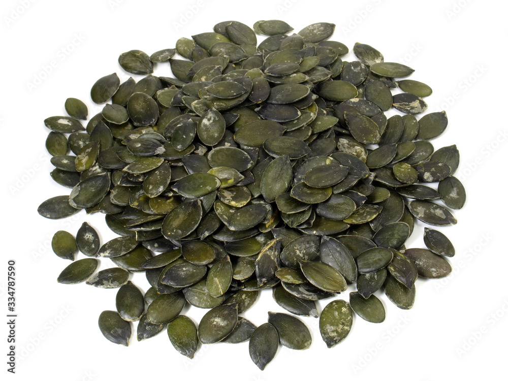 Dried Green Pumpkin Seeds on white Background Dried Green Pumpkin Seeds on white Background