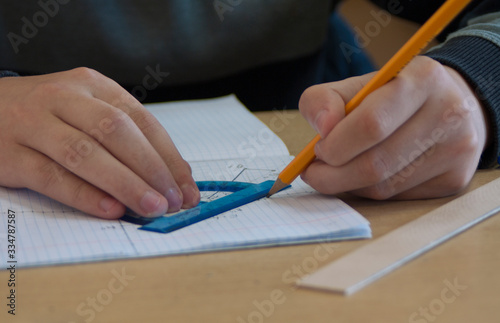 Photography the student draws a task on descriptive geometry